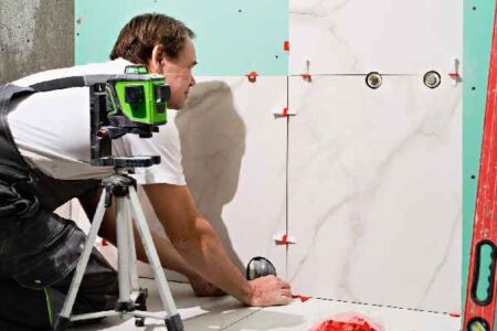 Stunning bathroom renovation transformation with new modern tile flooring and walls