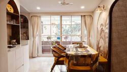 The heart of the home, where classic elegance meets modern comfort Spacious Japandi-style living room in a Bangalore 3BHK apartment with arched design.