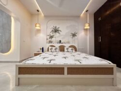 Serenity in simplicity. A serene Japandi master bedroom with a natural cane headboard and a textured, minimalist feature wall.