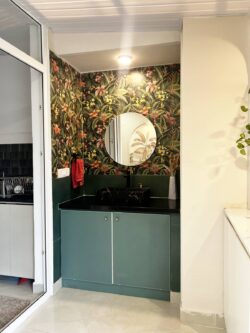 Petite in size, grand in design Luxurious and compact powder room with a vessel sink, framed mirror, and feature tile wall.