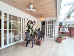 An all-weather retreat for all seasons. A cozy sitting balcony with a wood-look PVC ceiling and large sliding UPVC windows.