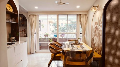 Spacious Japandi-style living room in a Bangalore 3BHK apartment with arched design.